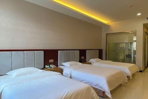 A hotel room with three beds, a wooden headboard, a bedside table with a phone, and a glass door leading to a bathroom. - Lijing Haiwan Hotel (Shenzhen)