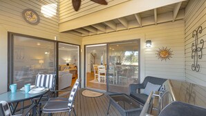 A covered outdoor patio with a dining table and chairs, a wicker sofa, and a ceiling fan. - Family Villa w/ Large Deck&Golf Views, Near Pool/Beach, Bikes (Hilton Head Island)