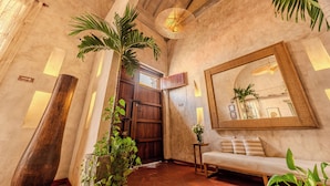 A spacious hallway with a wooden door, a large mirror, and a bench. - Moet Cartagena Hotel Boutique  - Adults Only (Cartagena)