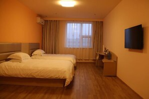 A hotel room with two beds, a desk, a TV, and a window with curtains. - Grace Inn (Yutai Bus Station) (Yutai)