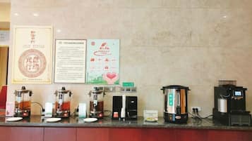 A coffee station with multiple coffee makers and a menu board.