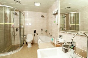 A modern bathroom with a glass-enclosed shower, a bathtub, a toilet, and a sink with a mirror. - Jixi International Hotel (Jixi)