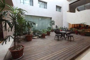 A wooden deck with potted plants and outdoor furniture. - Jixi International Hotel (Jixi)