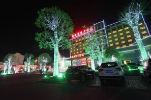 A hotel with illuminated trees and a brightly lit building facade. - Jixi International Hotel (Jixi)