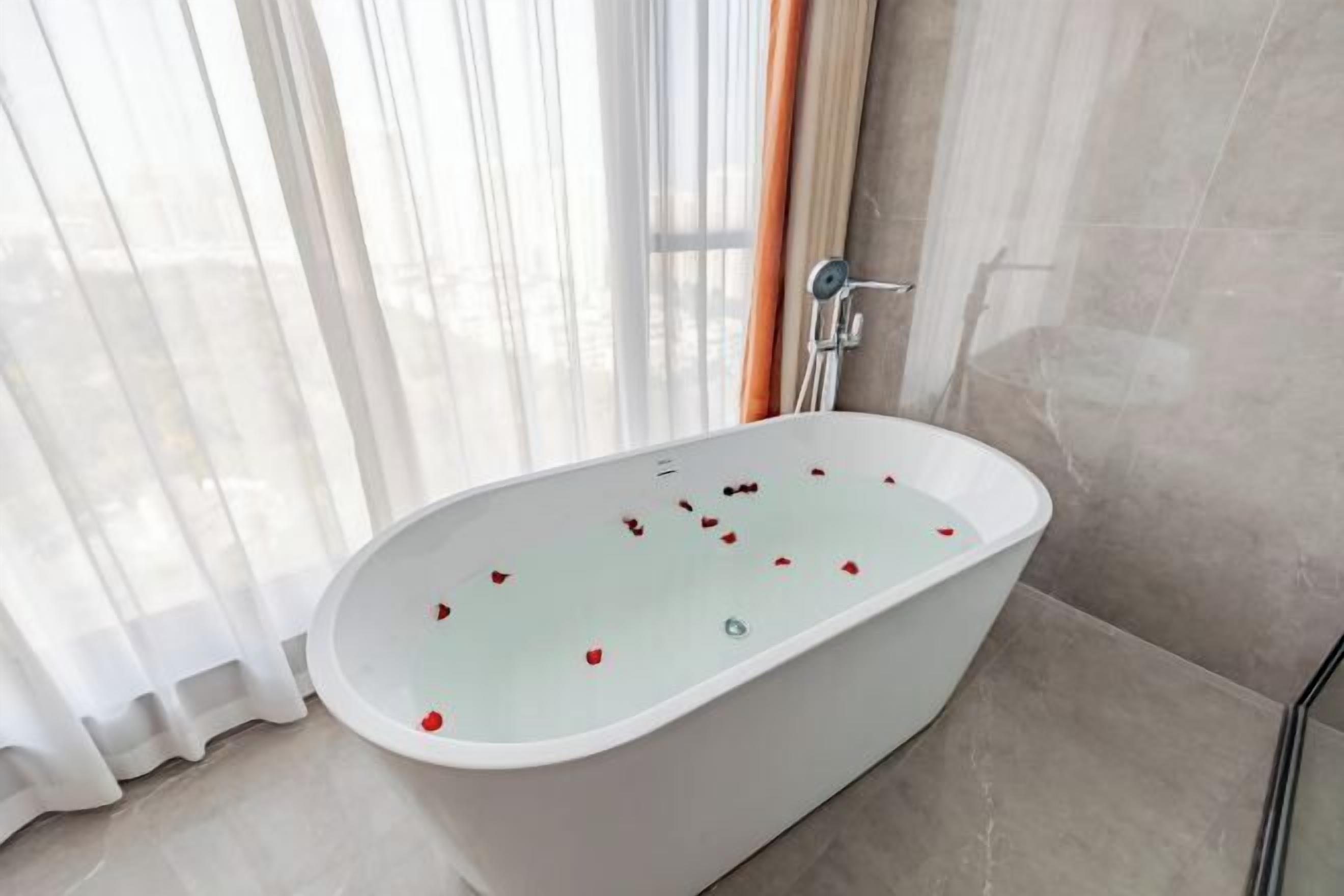 A modern bathroom with a freestanding bathtub, a shower, and a glass shower enclosure.