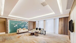 Un salon moderne comprenant un ensemble de canapés, une table basse et un grand élément décoratif mural.