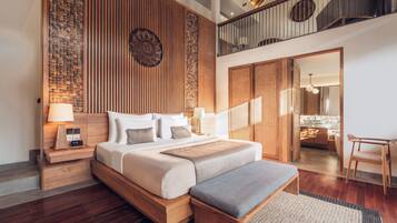 A modern bedroom with a wooden bed, bedside tables, a bench, and a view of a kitchen and balcony.