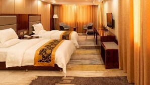 A hotel room with two beds, a desk, a chair, a TV, and a large window with curtains. - Pizhou Melvo Hotel (Pizhou)