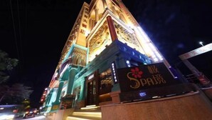 A multi-story building with illuminated signage and traditional architectural elements. - Moon Palace Hotel Huizhou (Huizhou)