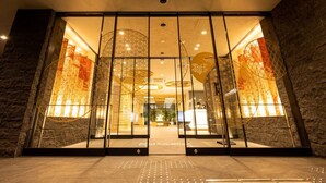 A hotel entrance with a glass facade, a reception desk, and a modern interior design. - La'gent Hotel Kyoto Nijo (Kyoto)