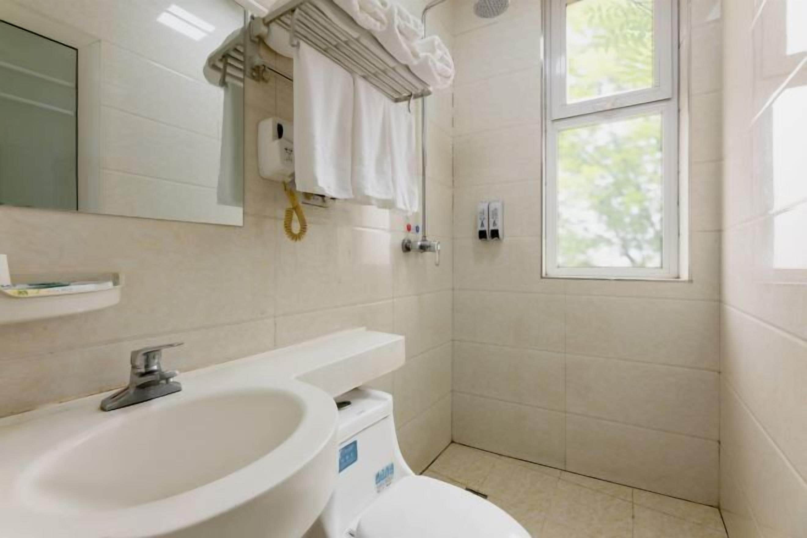 A bathroom with a sink, toilet, and shower.