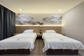 A hotel room with two beds, a nightstand, a wall-mounted lamp, and a painting of mountains and birds. - Xinhuangdu Hotel, Xupu (Lipu)
