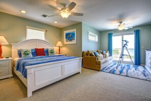 A bedroom with a bed, nightstands, a dresser, a window, a ceiling fan, and a view of the outdoors. - Slice of Paradise: Big Pine Key Waterfront | Heated Pool, Dockage & Open-Water Views (Big Pine Key)