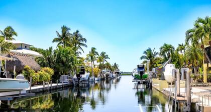 Slice of Paradise: Captivating Open Water Views, Deep Canal, Dockage, Heated Pool, and Pet-Friendly!