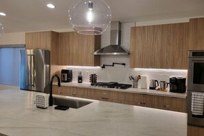 Fridge, oven, coffee/tea maker, cookware/dishes/utensils