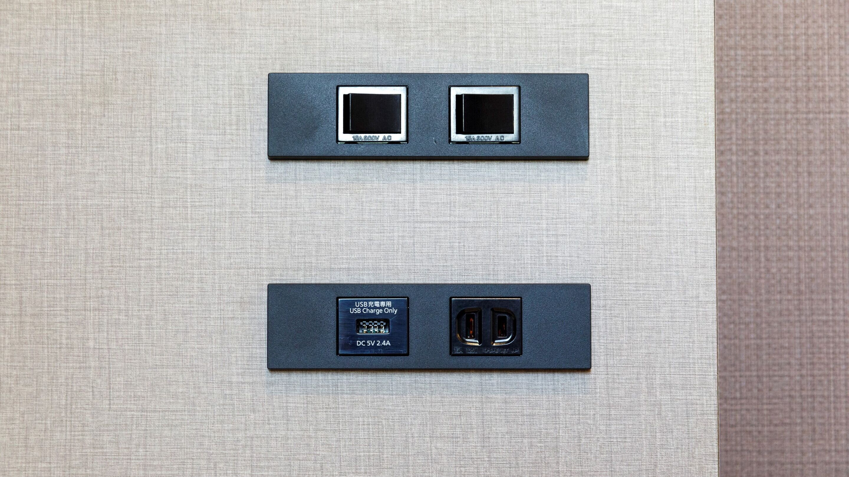 A wall with two USB charging ports and a power outlet.