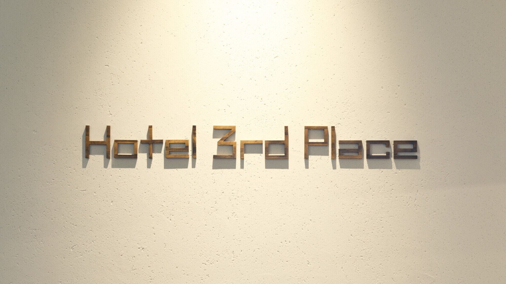 A wall with the text 'Hotel 3rd Place' in wooden letters.
