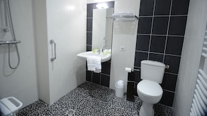 A bathroom with a shower, sink, and toilet. - Apartment n°2 (T3) two bedrooms with terrace ground floor (Saint-Vincent-de-Cosse)