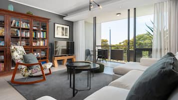 Business Apartment | Living area | 50-inch flat-screen TV with cable channels, TV