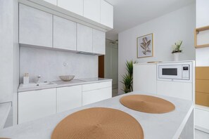 Fridge, stovetop, dishwasher, coffee/tea maker