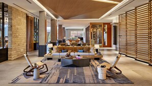 A spacious lobby with a central seating area, a large coffee table, and a patterned rug. - Omni Tempe Hotel at ASU (Tempe)