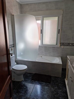 Bathtub, hair dryer, towels, soap