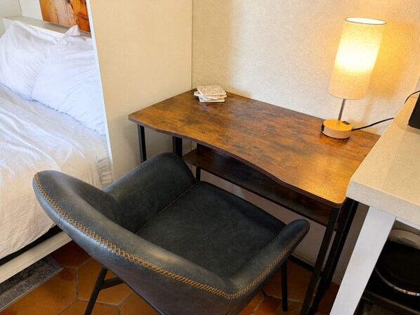A hotel room with a bed, a desk with a lamp, and a chair. - Lakefront Escape | Pool • Spa • 4 Min to Downtown (Chandler)