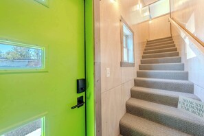 A staircase with a sign thanking guests for removing their shoes. - YCC Studio (West Yellowstone)