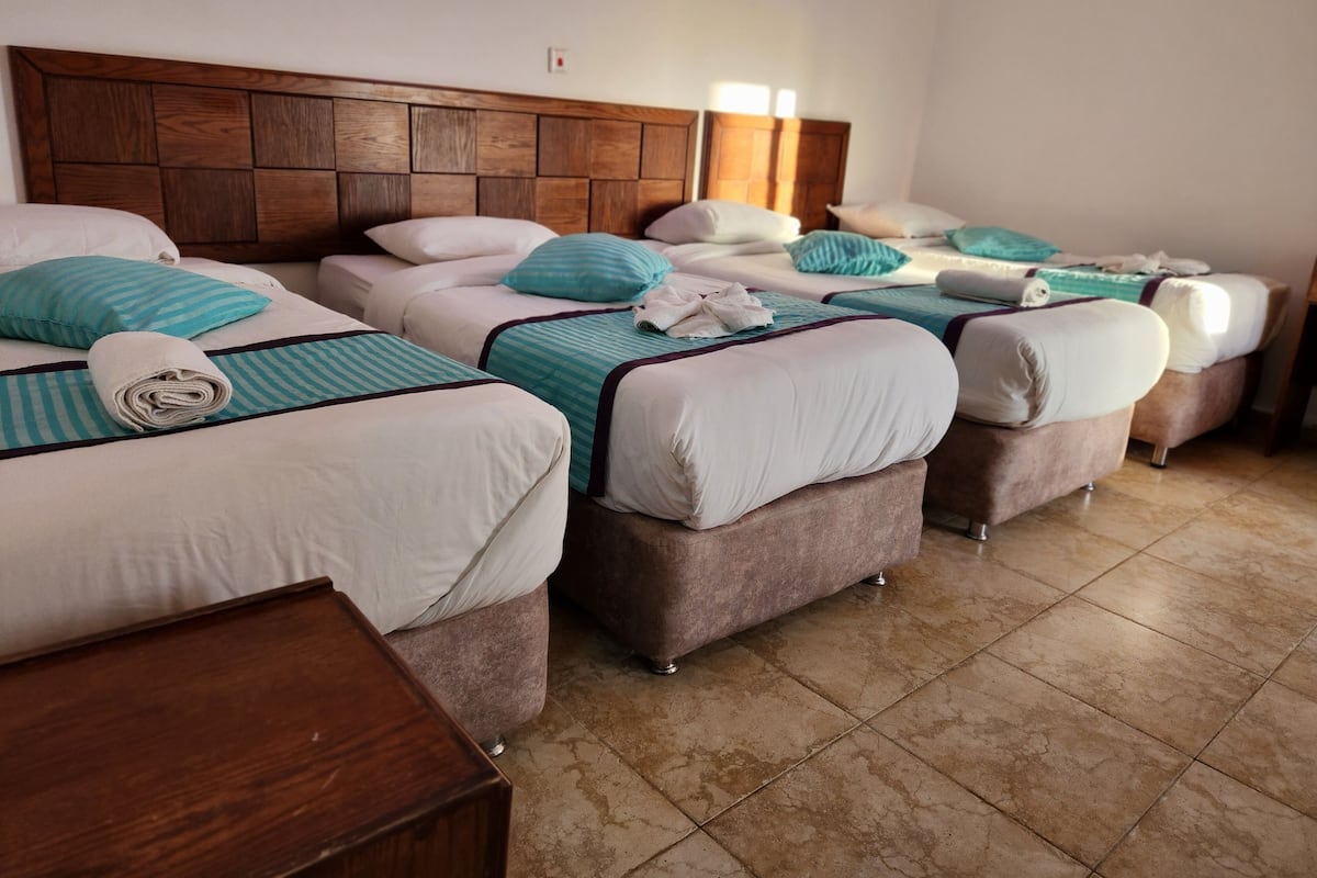 Deluxe Quadruple Room, 1 Bedroom, Balcony, Poolside | Hypo-allergenic bedding available, down comforters, Tempur-Pedic beds