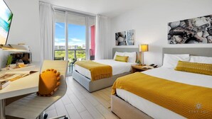 A hotel room with two beds, a desk, a TV, and a balcony with a city view. - Modern Condo : Amazing Pool + Gym + Balcony (Hallandale Beach)