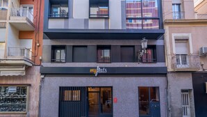 A multi-story building with a storefront labeled "my flats." - Estudio Prime (Alicante (Alacant))