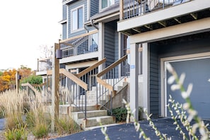 Stunning multi-story building with a prominent staircase and beautifully landscaped garden.