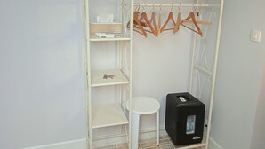 A white metal wardrobe with shelves, a hanging rack, and a small stool. - La Lisière du Morvan (Magny-Lormes)