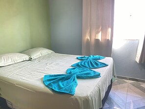 Relax in a cozy space with a neatly made bed and stylish decor.