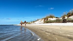 A beach with sand dunes and sparse vegetation. - Private Pool and Dock, Steps from the Beach, Beautiful Sunset Views (Saint Helena Island)