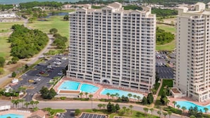 A high-rise hotel with multiple balconies, a swimming pool, and a view of the ocean. - Ariel Dunes II Penthouse 2403 - Top-Floor, Terrace Balcony, Stunning Gulf Views! (Miramar Beach)