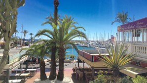 A marina with boats, a restaurant named 'Taj Mahal Restaurant', and palm trees. - Villa EDEN 2399 private pool & sea view (San Roque)