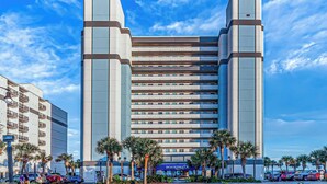 A modern hotel with a symmetrical facade, multiple floors, and a prominent Boardwalk sign.