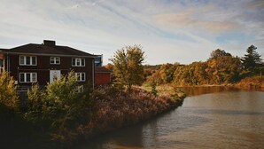 A house by a river with a clear sky.