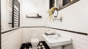 A small bathroom with a toilet, sink, and towel rack. - Torre 1 in Oporto With 1 Bathrooms (Porto)