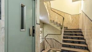 A staircase with marble steps and a metal railing, leading to an upper floor. - RA - Santa Catarina in Oporto (Porto)