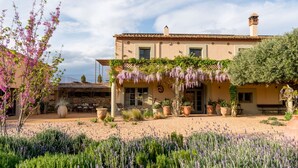 A Mediterranean-style building with a courtyard, outdoor seating, and a garden with lavender. - CAN CASI HOUSE (Parlava)