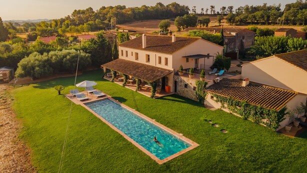 A large house with a swimming pool, surrounded by a well-maintained lawn and trees. - CAN CASI HOUSE (Parlava)