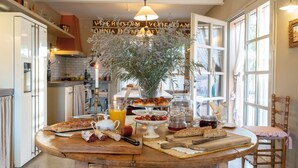 A kitchen with a wooden island, a hanging light fixture, and a decorative wall sign. - CAN CASI HOUSE (Parlava)