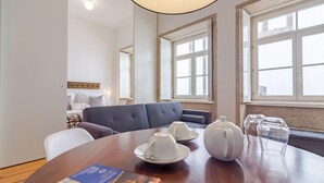 A dining area with a wooden table, two white teapots, two cups, and a book. - Tower 5F in Oporto With 1 Bathrooms (Porto)