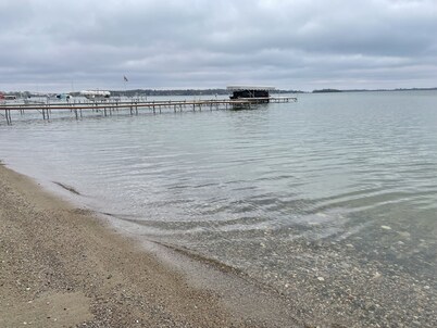 Enjoy this beach front lake home that boasts 66' of frontage with many amenities