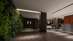 A modern lobby with a green wall, wooden flooring, and a reception desk. - Wyndham Grand Zhaoqing Downtown (Zhaoqing)