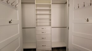 A walk-in closet with multiple shelves, drawers, and hanging rods. - Cityline suite Three miles to PC, RIC, BROWN, JWU, &RISD (North Providence)