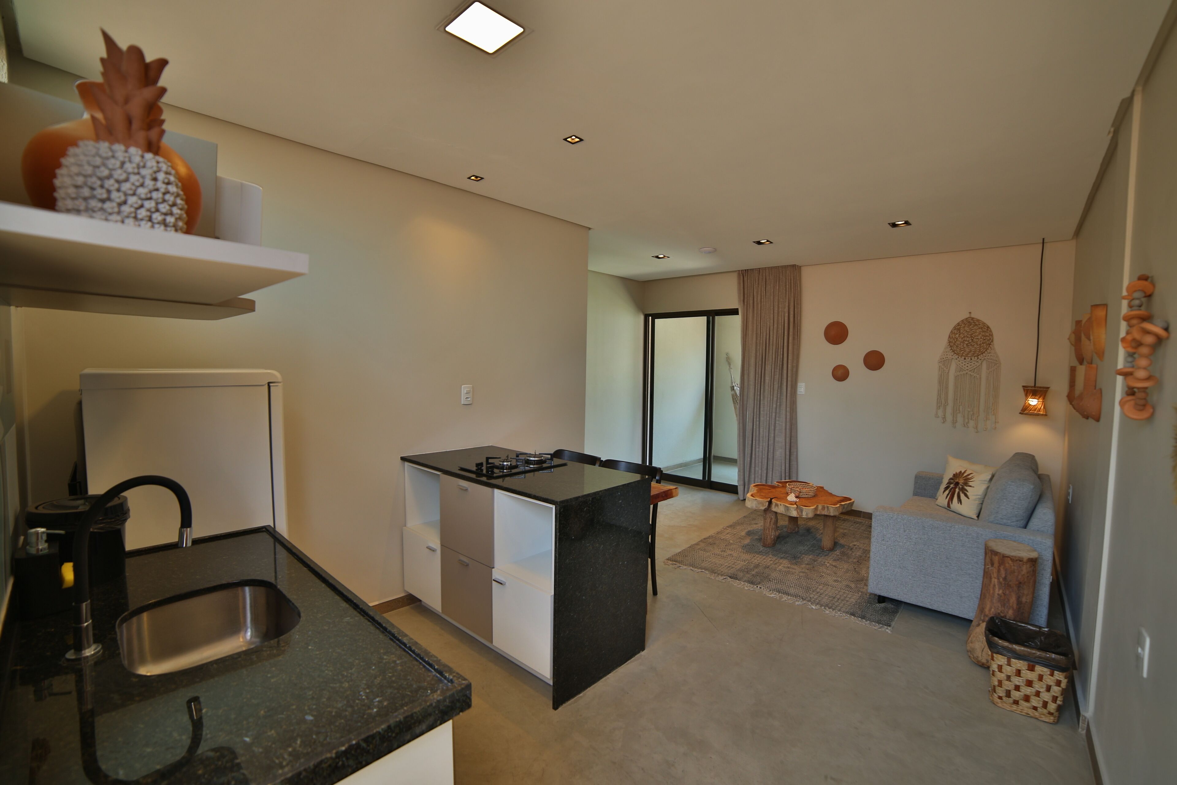 A compact living space with a kitchenette, a sofa, and a dining area.