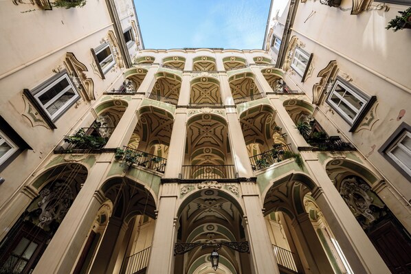A building with multiple balconies and arched windows.